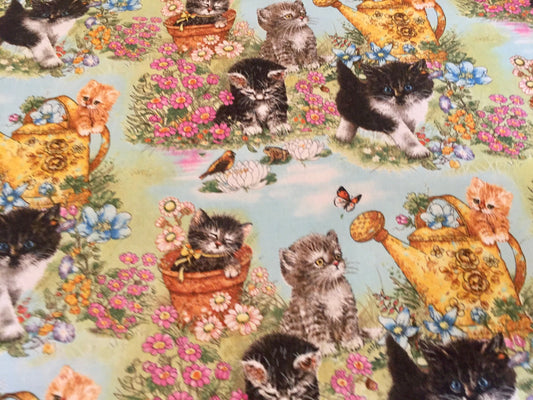 Beautiful kittens playing in a garden blanket